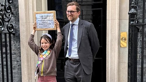 Freddie with campaigner Claudia and her petition outside 10 Downing Street
