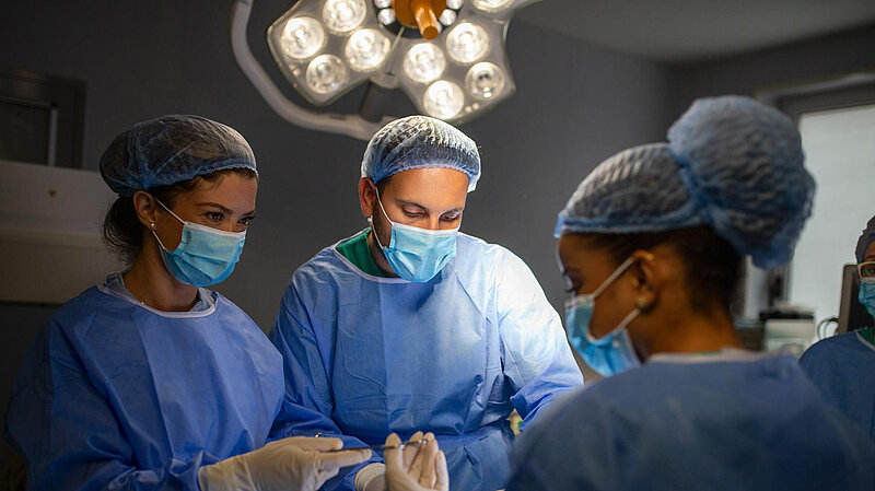 Surgeons operating in theatre