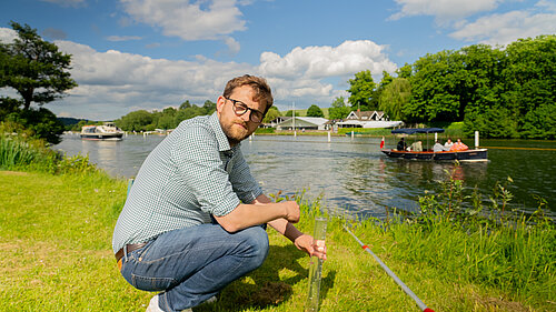 Freddie next to the river Thames testing water quality