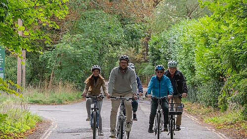 Freddie cycling in Goring with local Councillors and residents