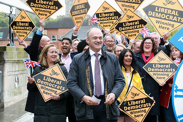 Ed Davey in front of crowd with Lib Dem diamond signs