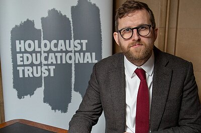Freddie signing the Holocaust Educational Trust's Book of Commitment