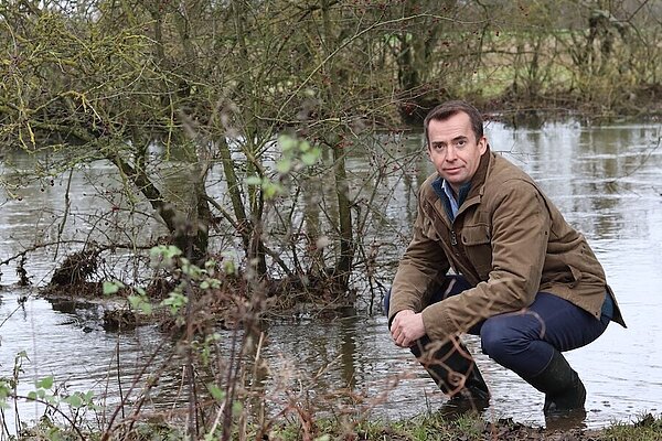 Calum examining polluted river