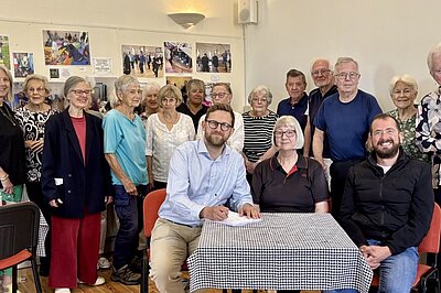 Freddie signing a petition with local campaigners