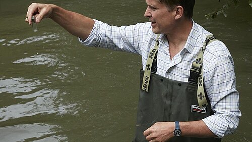 Charlie testing a local river's water quality