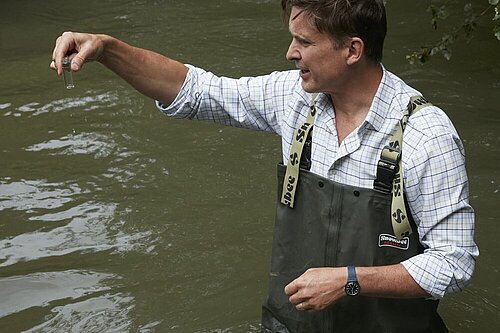 Charlie testing a local river's water quality