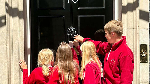 Children from Aston Rowant Primary School hand in a class petition to Number 10